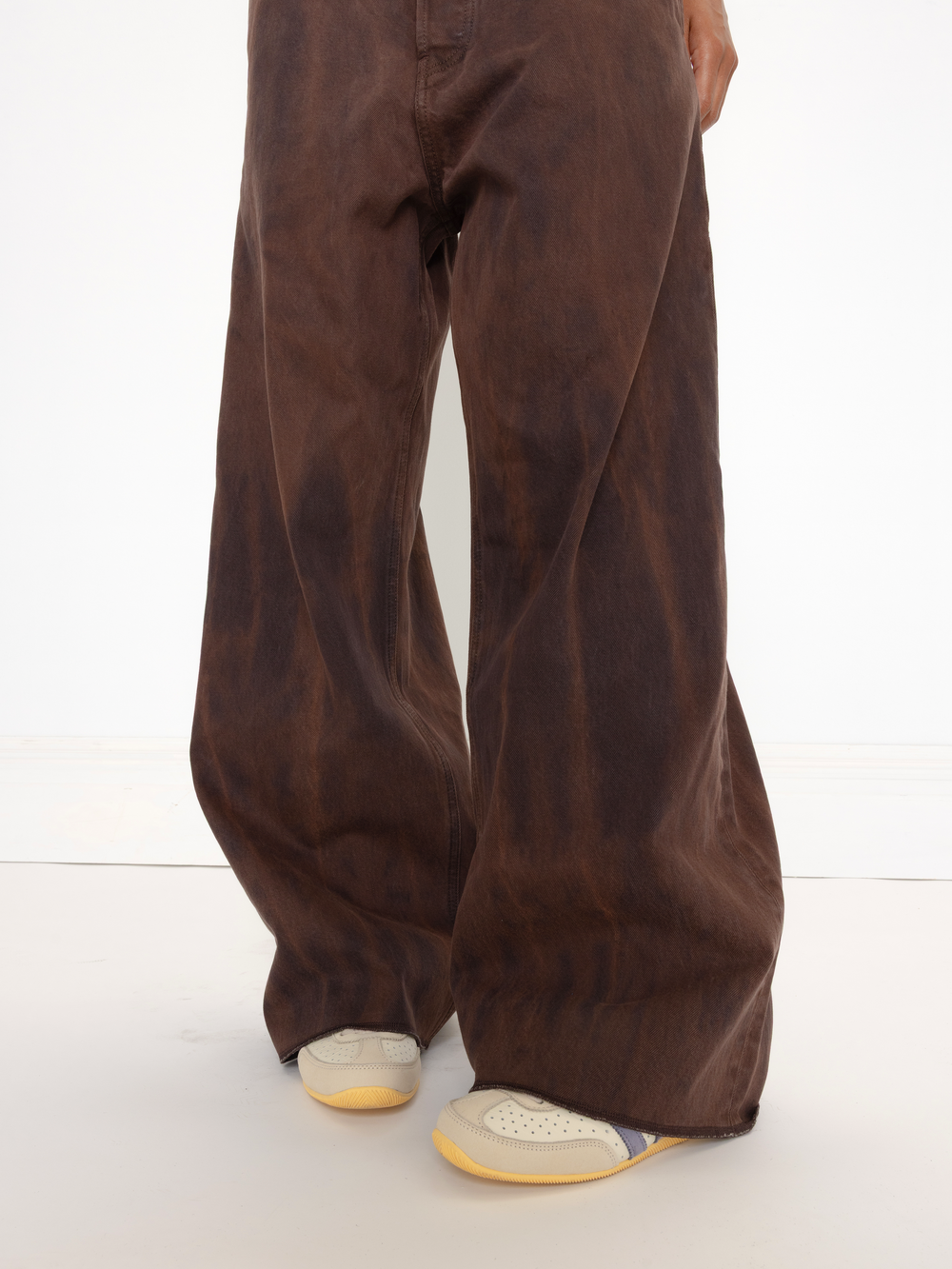 Brown wide-leg pants worn by a person on a white background