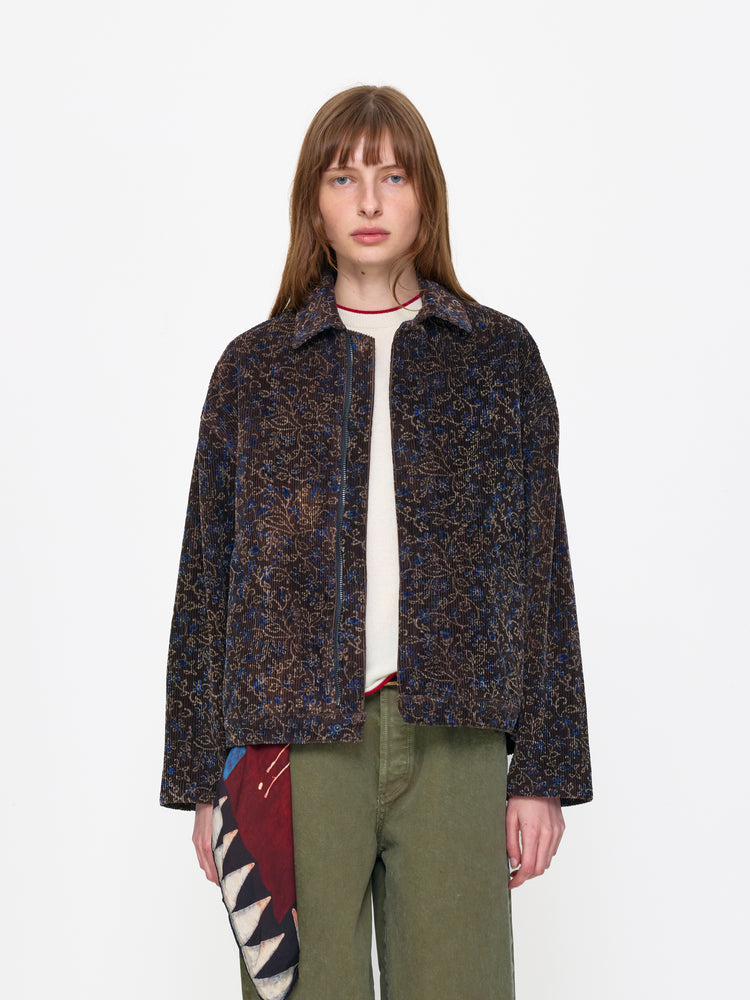 Woman wearing a patterned jacket on a white background