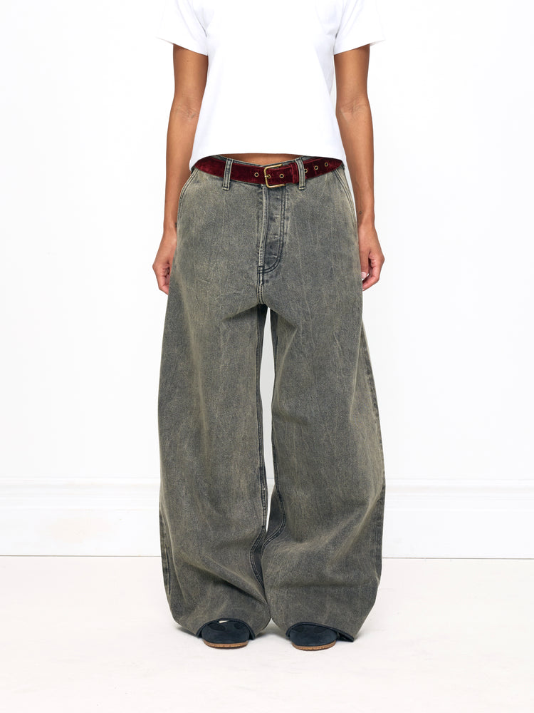 Person wearing wide-leg jeans and a white shirt on a white background