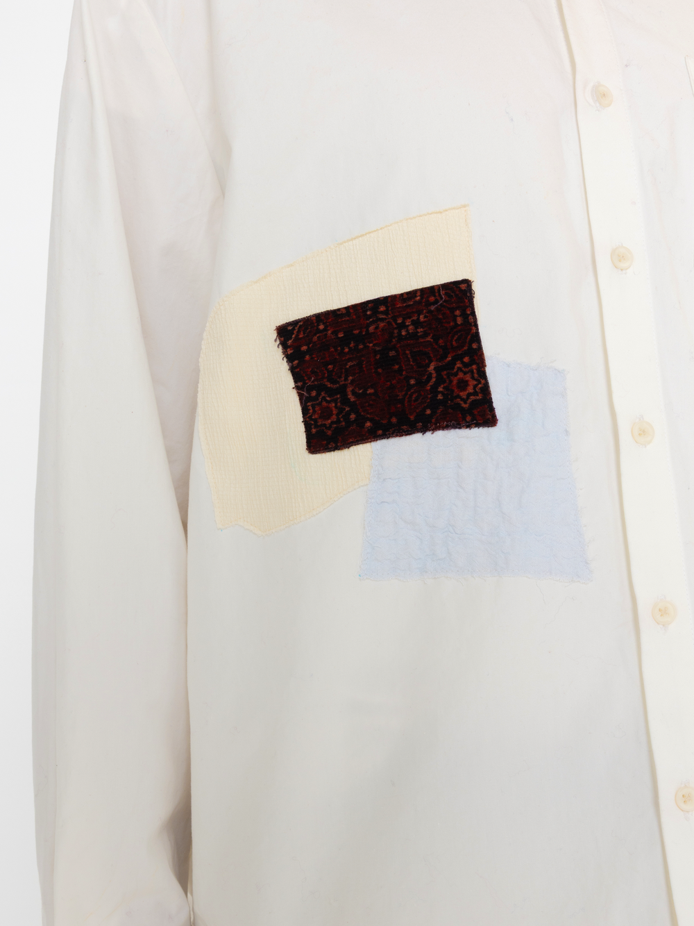 Close-up of a white shirt with a colorful patch on the chest